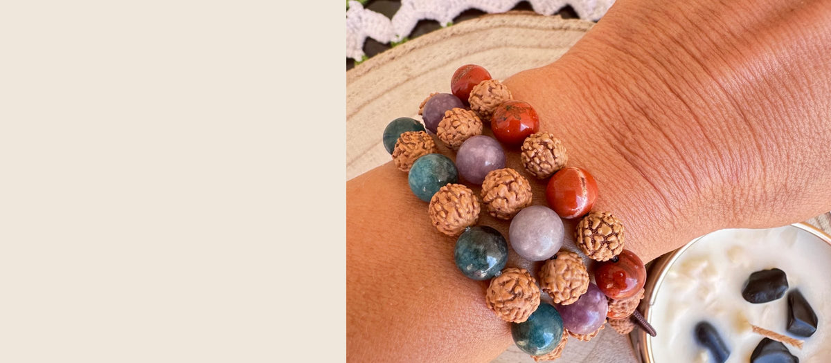 Tres pulseras de rudraksha y piedras naturales en la muñeca